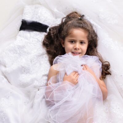 little girl in mom’s wedding dress